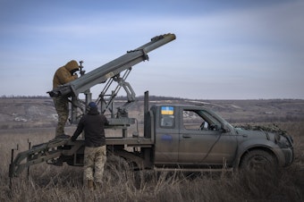 caption: Ukrainian soldiers from The 56th Separate Motorized Infantry Mariupol Brigade prepare to fire a multiple launch rocket system based on a pickup truck towards Russian positions at the front line, near Bakhmut, Donetsk region, Ukraine, March 5, 2024.