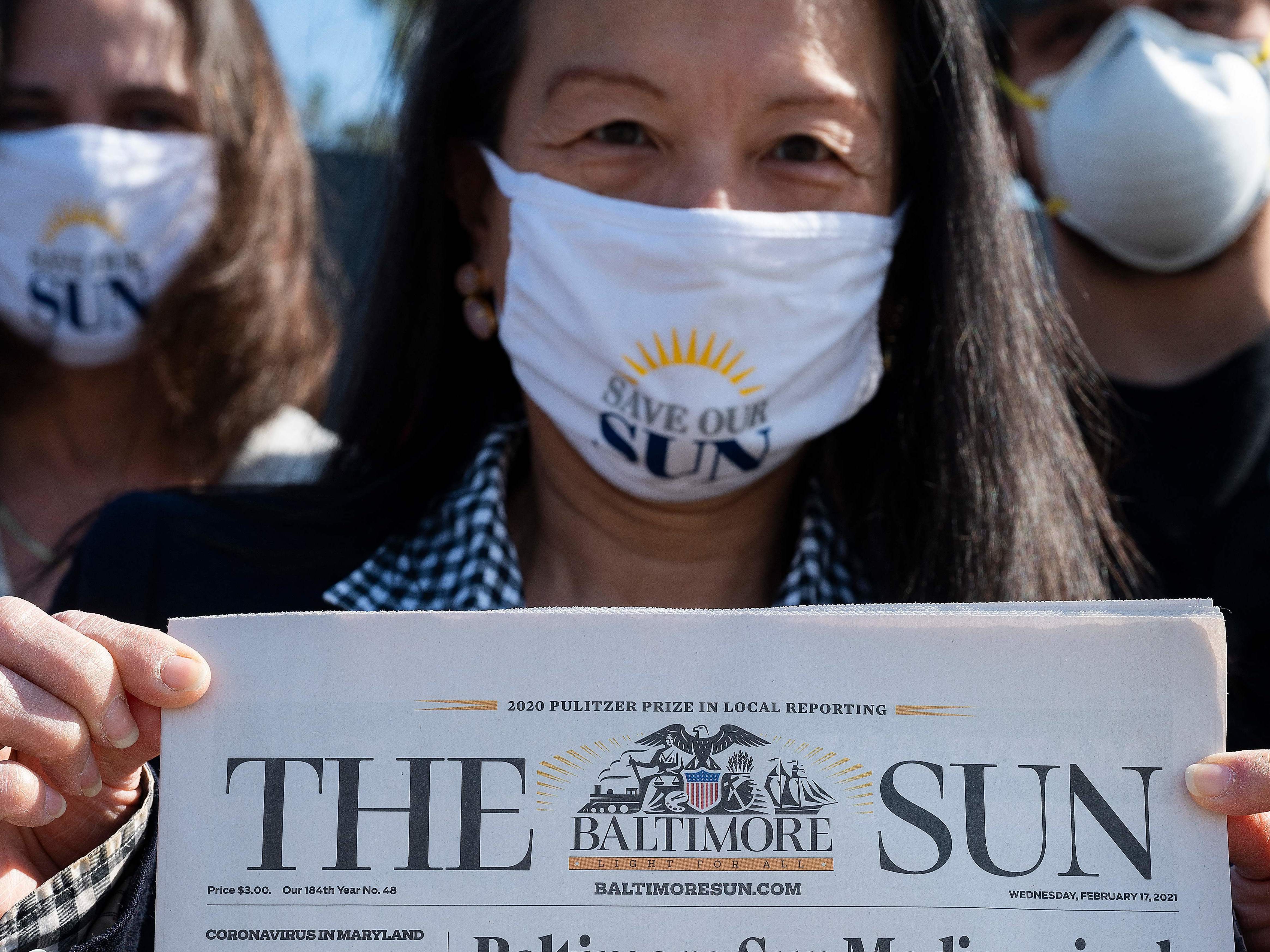 caption: <em>Baltimore Sun</em> reporter Jean Marbella participates in a Save Our Sun rally in March, part of an effort to secure an alternative buyer to Alden Global Capital.