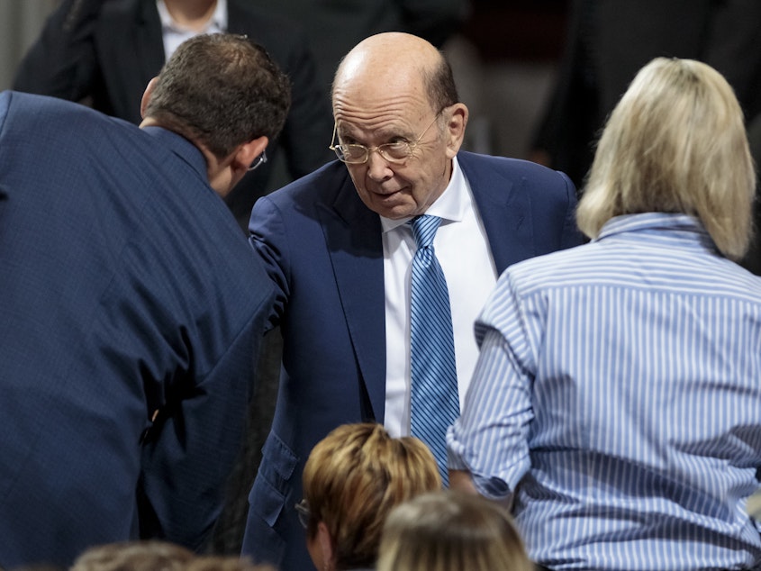 caption: Commerce Secretary Wilbur Ross attends a July speech by President Trump in Granite City, Ill. The Supreme Court has temporarily shielded Ross from having to sit for questioning under oath for the 2020 census citizenship question lawsuits.