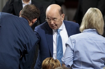 caption: Commerce Secretary Wilbur Ross attends a July speech by President Trump in Granite City, Ill. The Supreme Court has temporarily shielded Ross from having to sit for questioning under oath for the 2020 census citizenship question lawsuits.