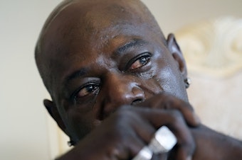 caption: Aaron Bowman cries during an interview at his attorney's office in Monroe, La., on Aug. 5, 2021, as he discusses his injuries resulting from a Louisiana State trooper pummeling him during a traffic stop in 2019.
