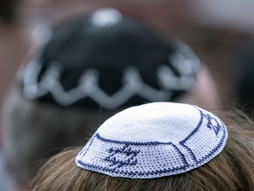 caption: People of different faiths wear the Jewish kippah during a demonstration against antisemitism in Germany in April.