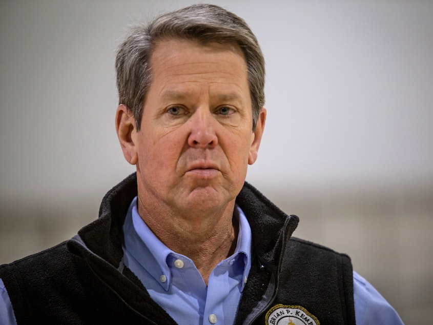 caption: Georgia Gov. Brian Kemp, pictured on April 16, insists he is moving forward with plans to allow some nonessential businesses to open their doors to the public. The plan has come under intense criticism.