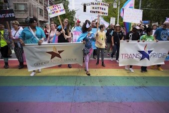 caption: The Trans Pride Seattle march crosses Broadway Street on Friday, June 22, 2018, near Cal Anderson Park in Capitol Hill.