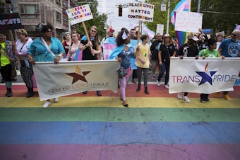 caption: The Trans Pride Seattle march crosses Broadway Street on Friday, June 22, 2018, near Cal Anderson Park in Capitol Hill.