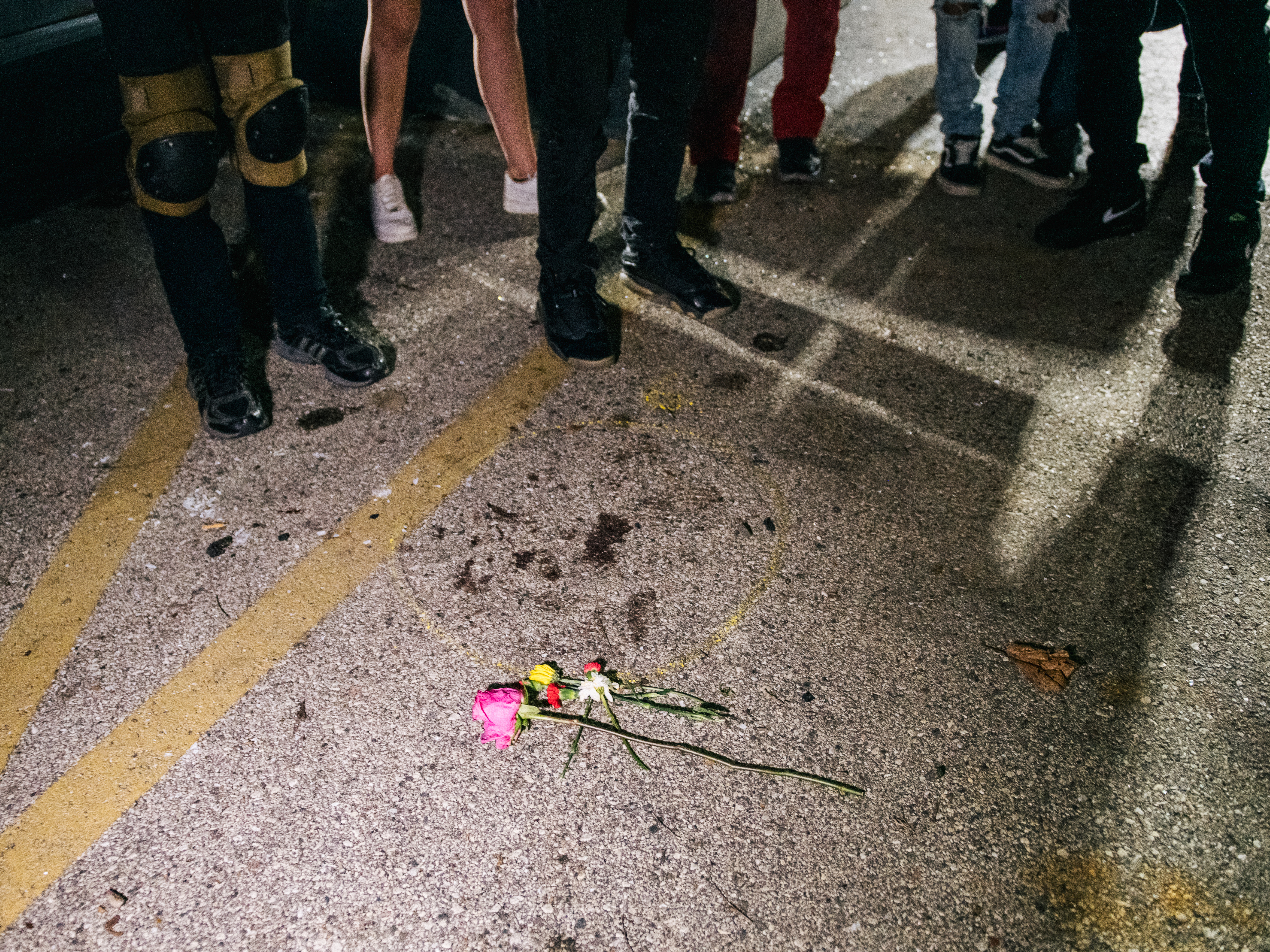 caption: Demonstrators revisit the site where a protester was killed in Kenosha, Wis. On Aug. 25, 17-year-old Kyle Rittenhouse shot and killed two protesters. He was charged on Thursday with six criminal counts, including first-degree intentional homicide.