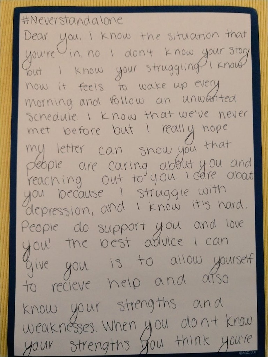 caption: High school sophomore students in Jennifer Ward's class in Grandville, MI write pick-me-up letters for peers inspired by Hannah Brencher's More Love Letters campaign.
