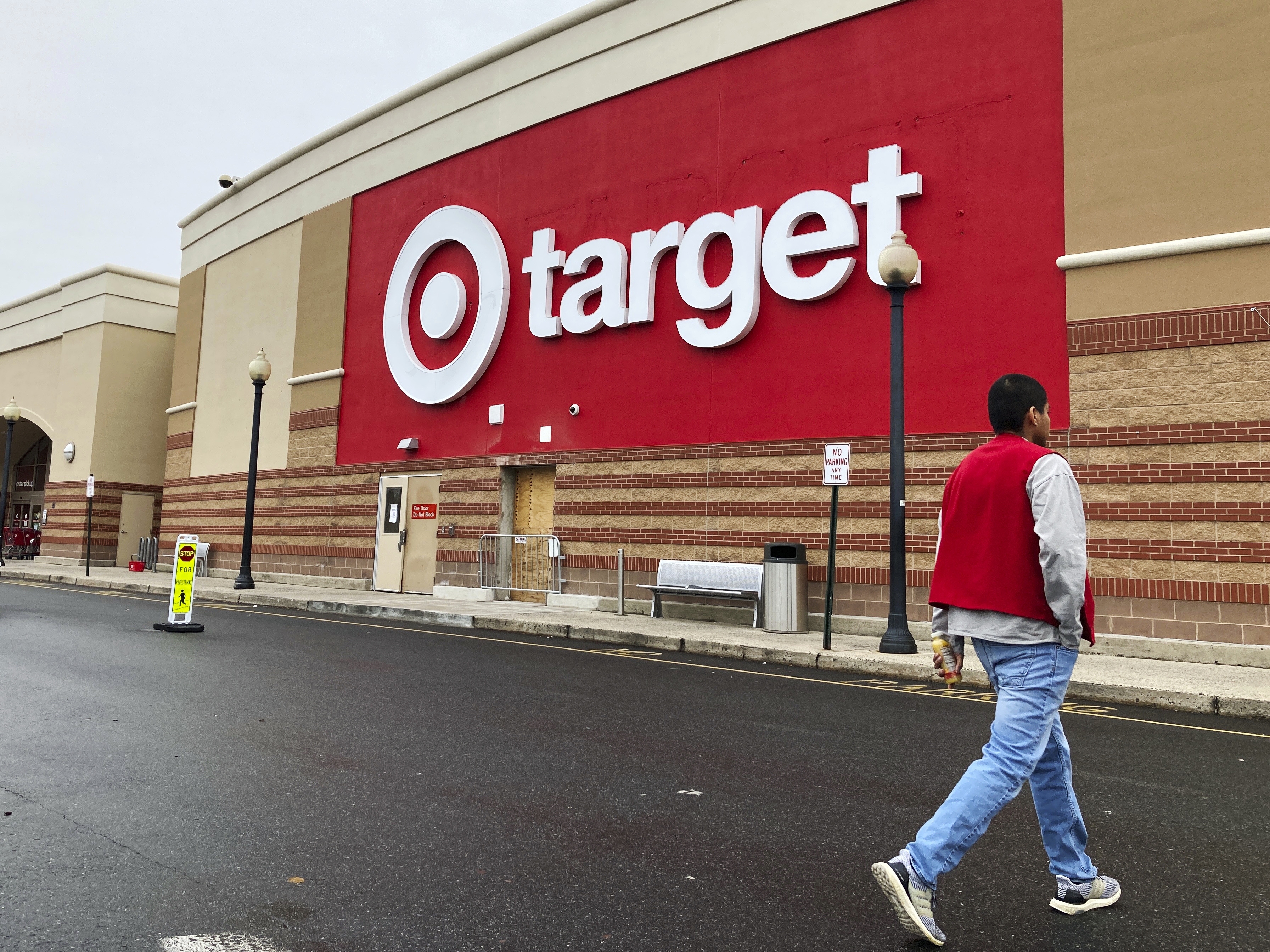 caption: Target on Wednesday became the latest retailer to lower its financial forecast for the year. It downplayed its plans for tariff-related price hikes.