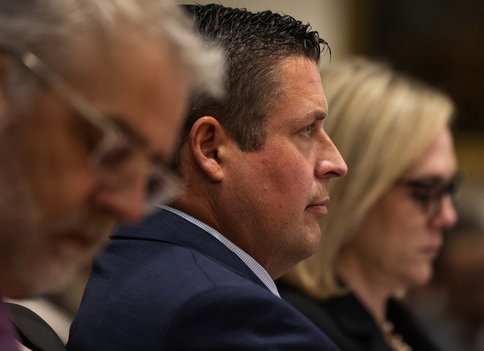 caption: Auburn Police Officer Jeffrey Nelson, center, is flanked by two of his defense attorneys as Nelson’s trial gets underway, Thursday, May 16, 2024, at the Maleng Regional Justice Center in Kent. On the left is Tim Leary, to the right is Emma Scanlan.