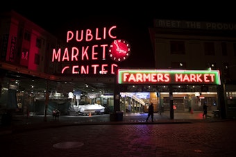 caption: Security guard Fritz Scharer patrols Pike Place Market at 3:53 a.m. on Monday, June 10, 2019, in Seattle.