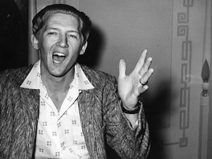 caption: Jerry Lee Lewis, in a photo taken during his infamous trip to London in June 1958, when it became public that he was married to his 13-year-old cousin.