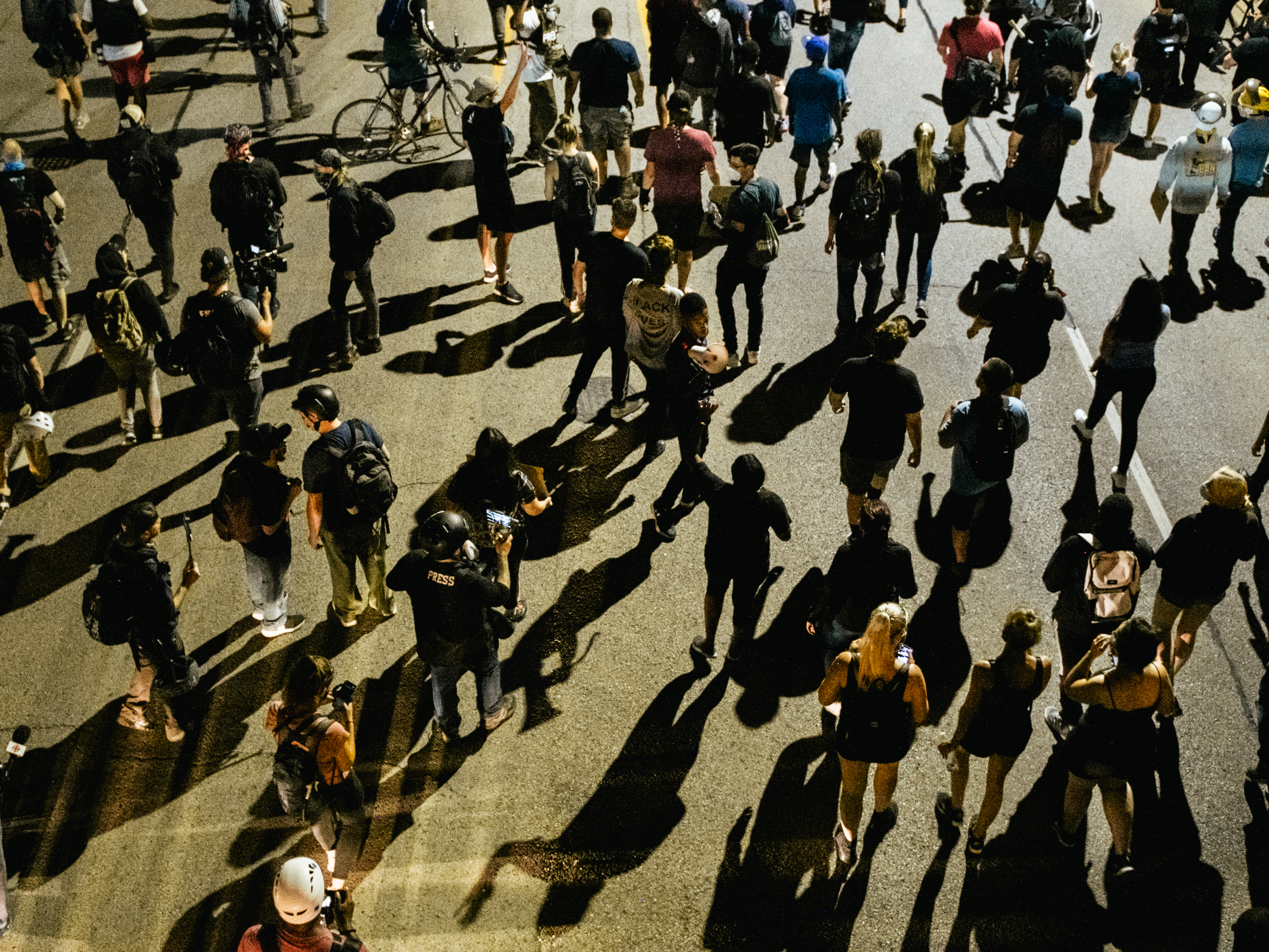 caption: Demonstrators march in the streets on August 26, 2020 in Kenosha, Wisconsin. As the city declared a state of emergency curfew, a fourth night of civil unrest occurred after the shooting of Jacob Blake, 29, on August 23.