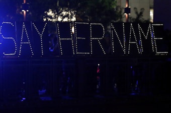 caption: Protesters hold up a lighted sign reading "#sayhername" during a July 2015 vigil for Sandra Bland in Chicago. Bland died in a Texas jail after a traffic stop escalated into a physical confrontation. Authorities said Bland hanged herself, a finding her family disputed.