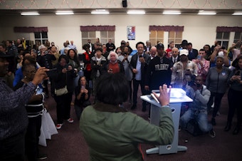 caption: Seattle City Council candidate in the 3rd District, Joy Hollingsworth, speaks to friends, supporters, and family members after initial results showed her in the lead during an election night party at the First AME Church on Tuesday, Nov. 7, 2023, in Seattle. 