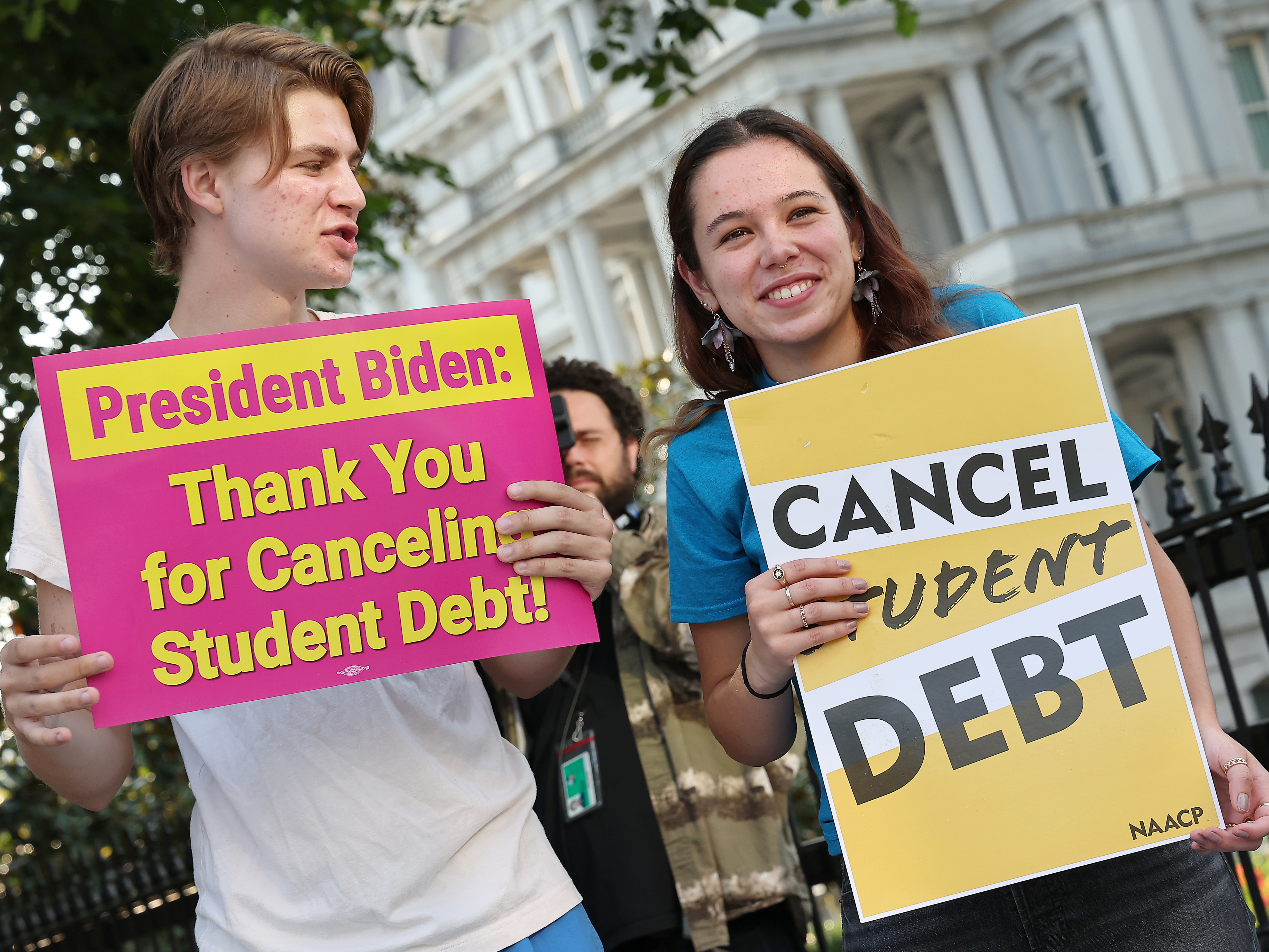 caption: Student loan borrowers stage a rally in front of The White House on Aug. 25 to celebrate President Biden cancelling student debt. The plan has sparked heated debate, including about its economic fairness.