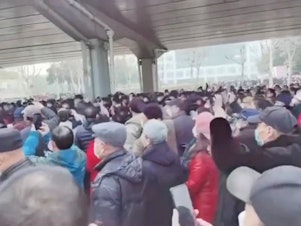 caption: Demonstrators gather outside Zhongshan Park in Wuhan, China, to protest changes to medical benefits, on Wednesday, in this still image from social media video obtained by Reuters.