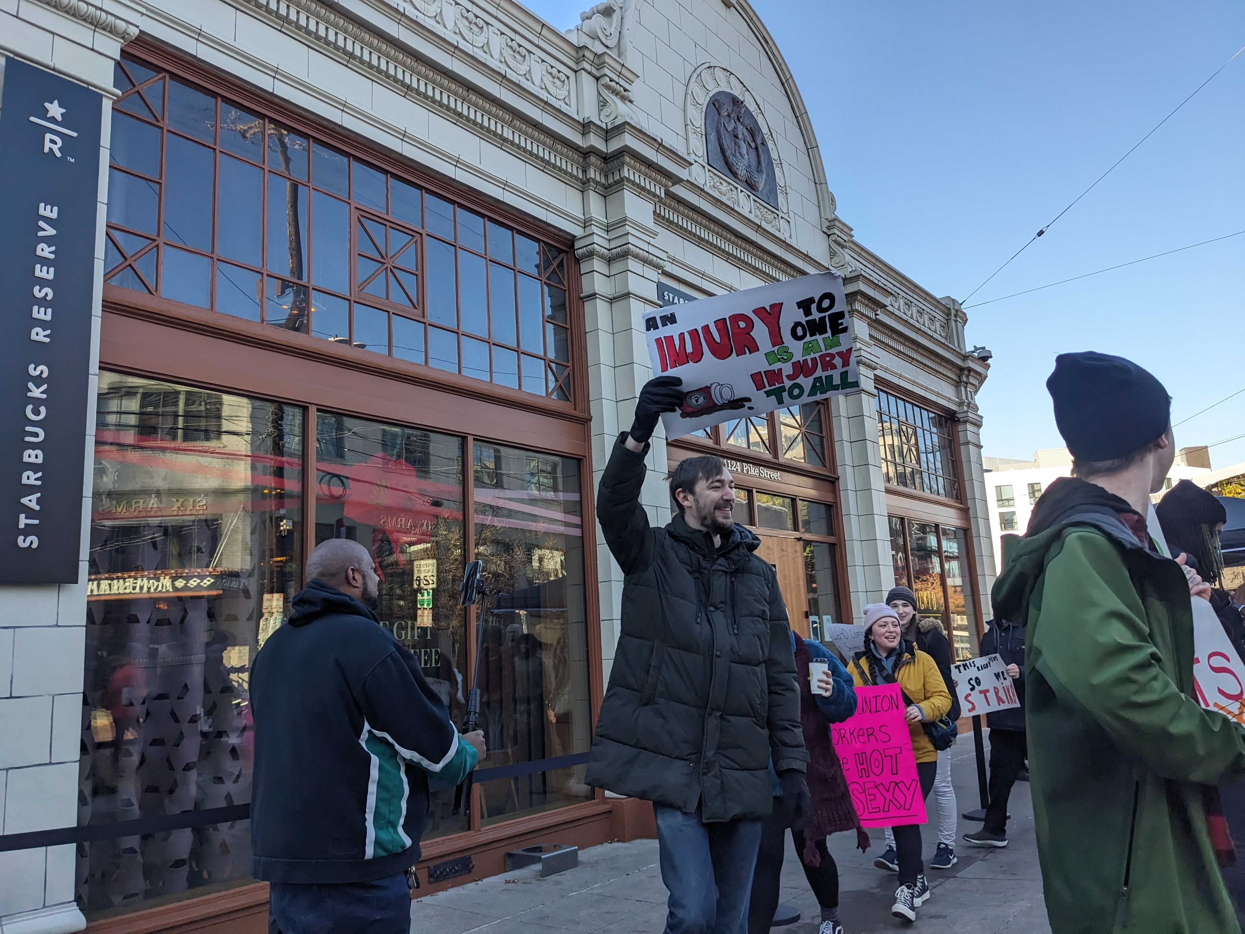 caption: Starbucks workers picket in Seattle's Capitol Hill on Thursday, Nov. 16, 2023.