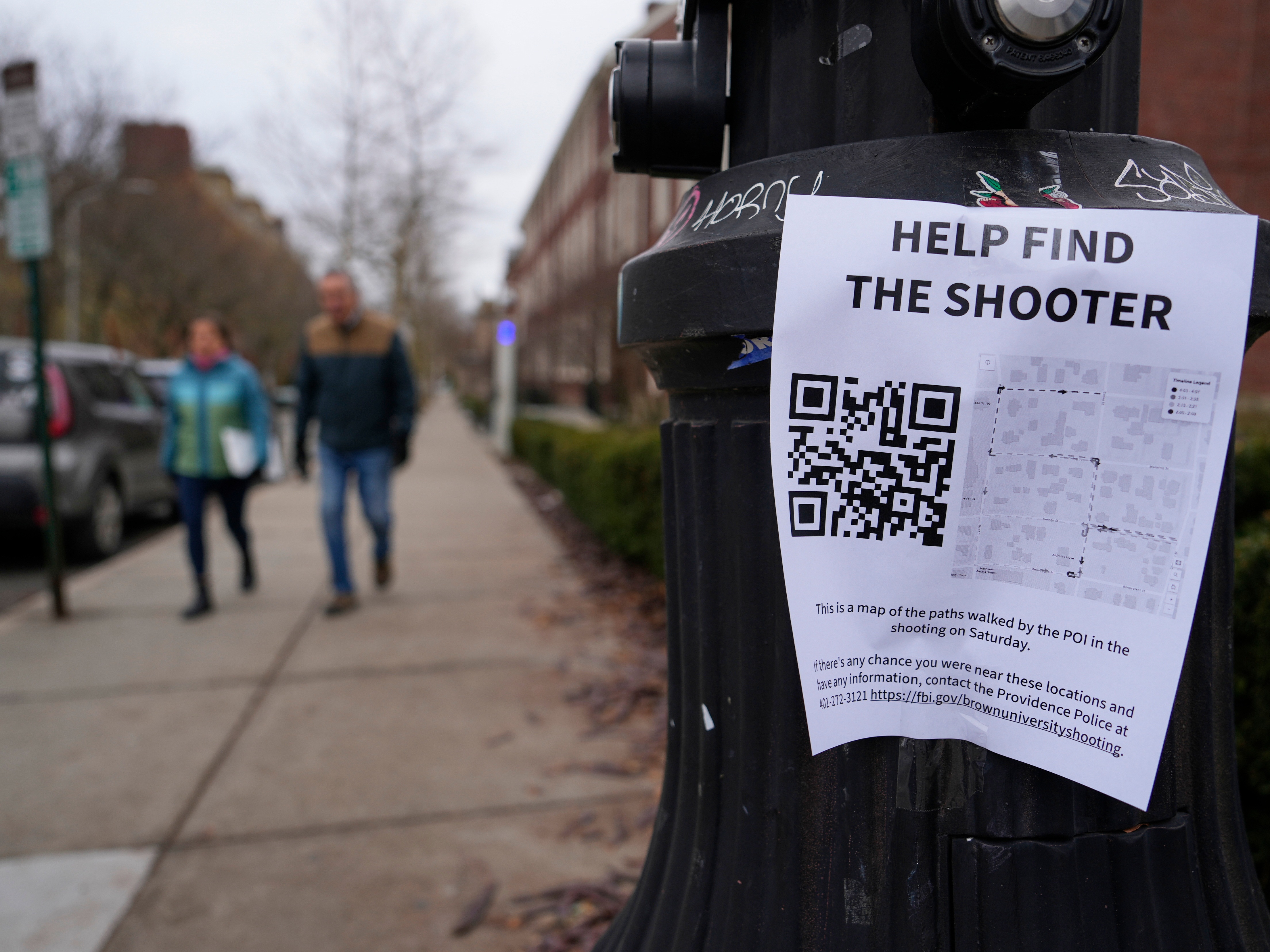 caption: A poster seeking information about the campus shooting suspect is seen on the campus of Brown University on Dec. 17, 2025, in Providence, R.I.