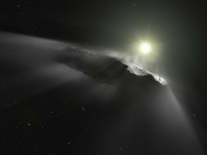caption: An artist's vision of the first interstellar object discovered in the solar system, 'Oumuamua.