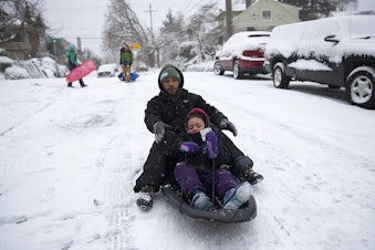caption: Bryan Baker sleds with his 5-year-old daughter Avery Baker on Monday, February 4, 2019, next to the West Queen Anne playfield at the intersection of 3rd Avenue West and West Howe Street in Seattle.