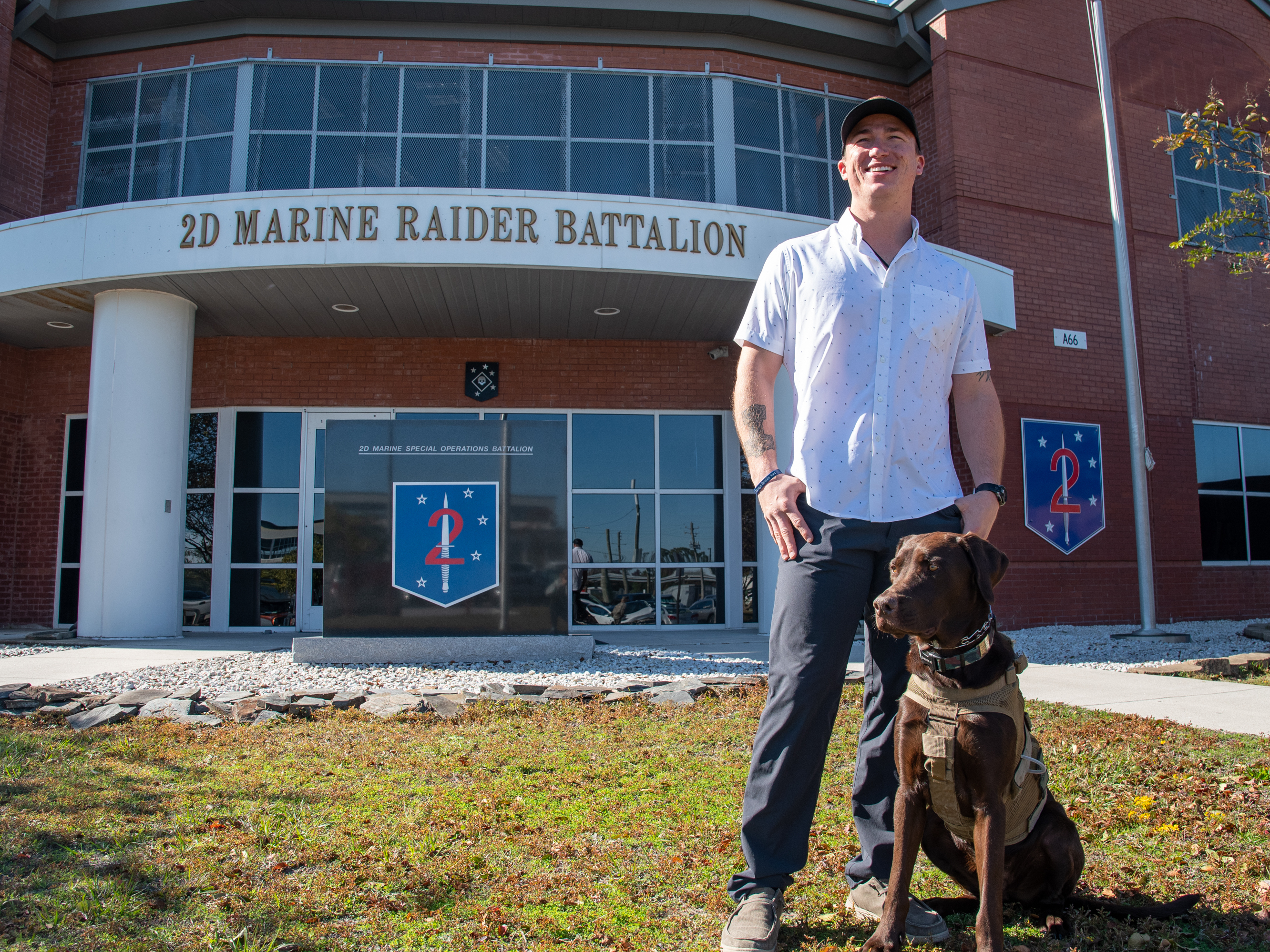 caption: Nick Jones at Marine Corps Base Camp Lejeune in Jacksonville, N.C., on Nov. 8 with his dog Fletcher. This Veterans Day will be Nick's first day as a civilian upon leaving the Marine Corps.