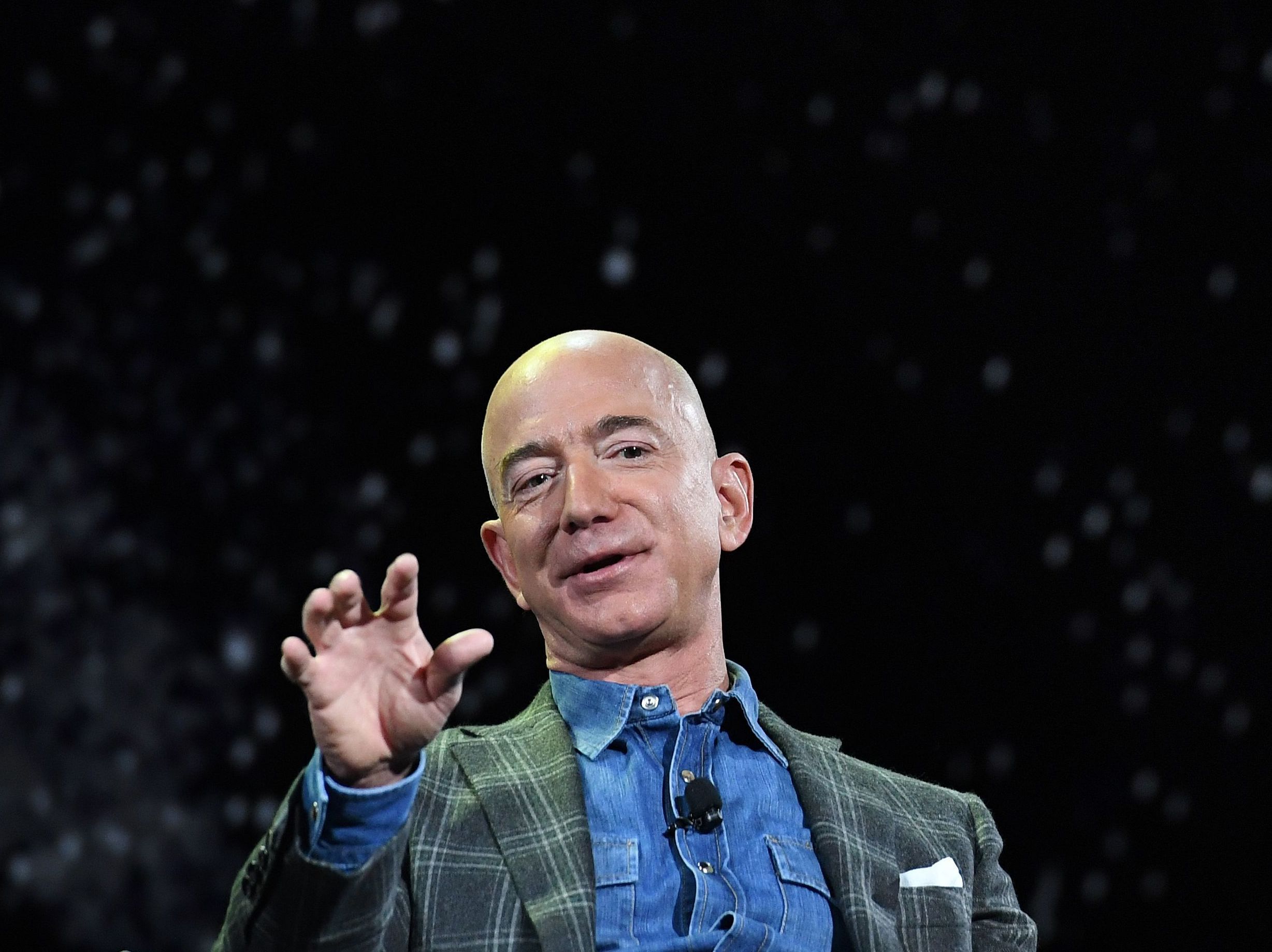 caption: Amazon founder and CEO Jeff Bezos announced he'll be on board a spaceflight next month, in a capsule attached to a rocket made by his space exploration company Blue Origin. Bezos is seen here in 2019.