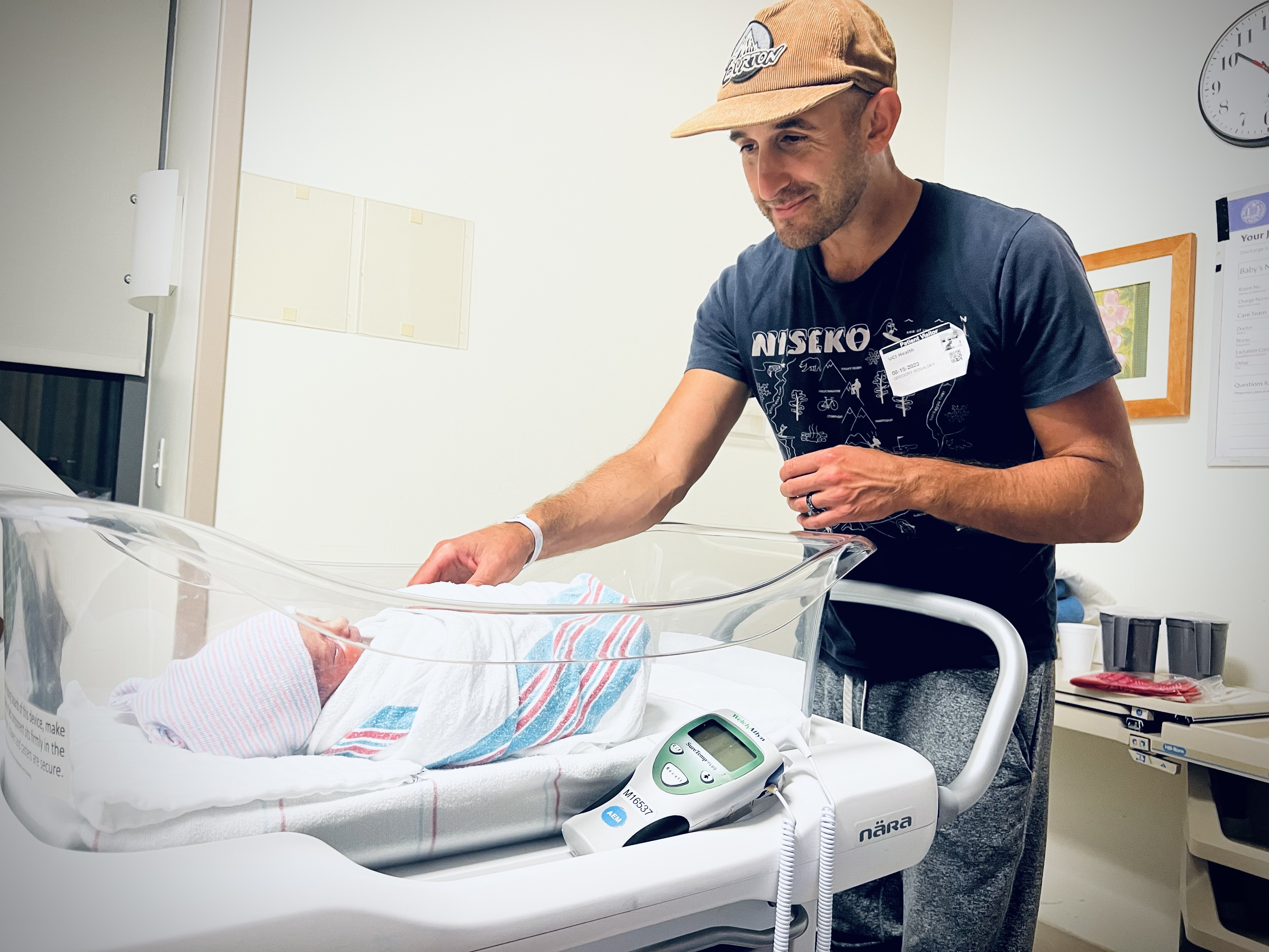caption: Greg Rosalsky looks at his new son in the hospital.