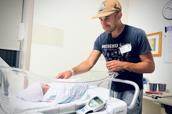 caption: Greg Rosalsky looks at his new son in the hospital.