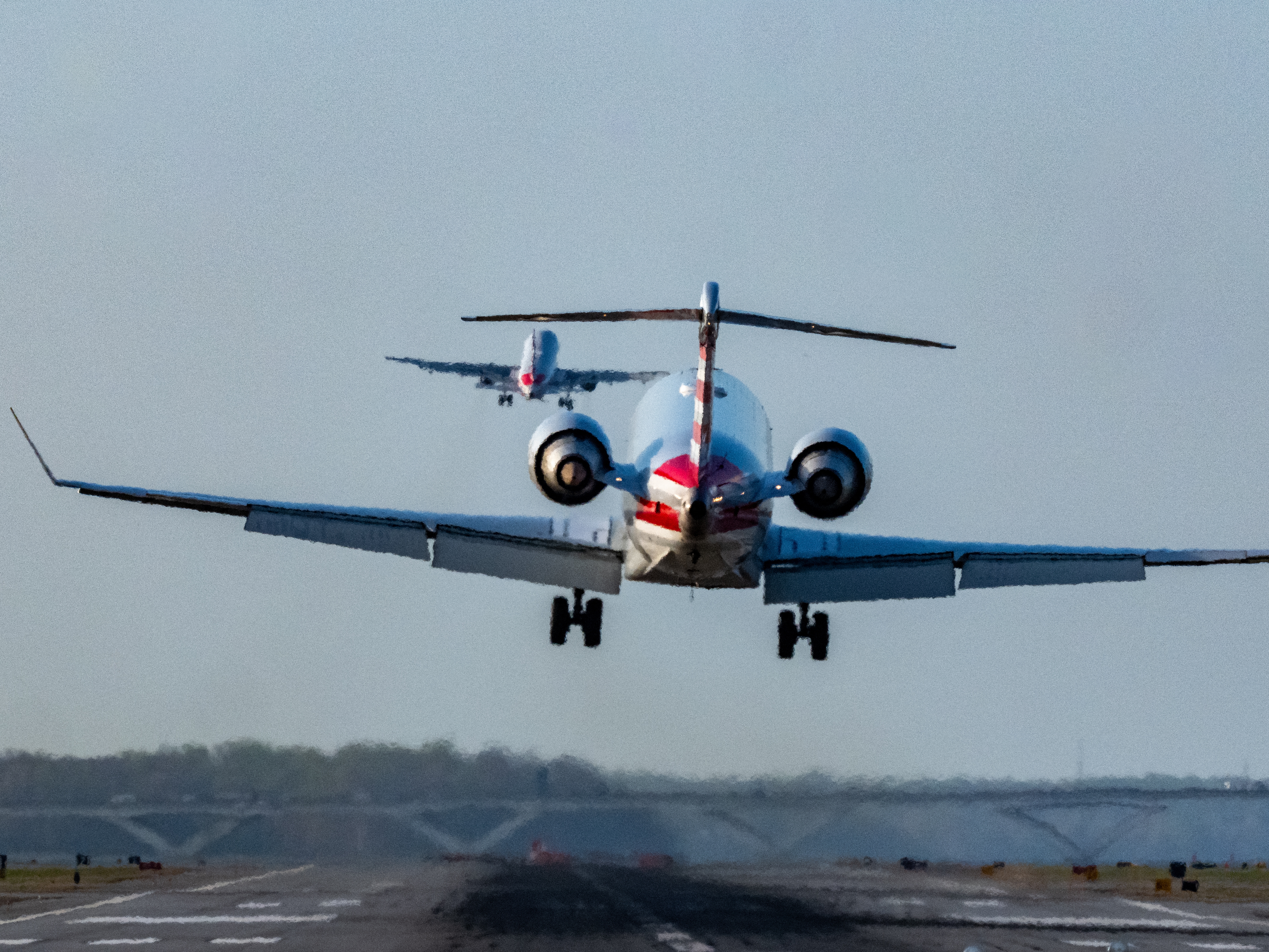 caption: The FAA says it wants to build a brand-new air traffic control system that uses software to prevent conflicts, delays and cancellations. Here, passenger jets land and take off at Ronald Reagan Washington National Airport in March. Last year, a midair collision between a regional airliner and a military helicopter near the airport killed 67 people.