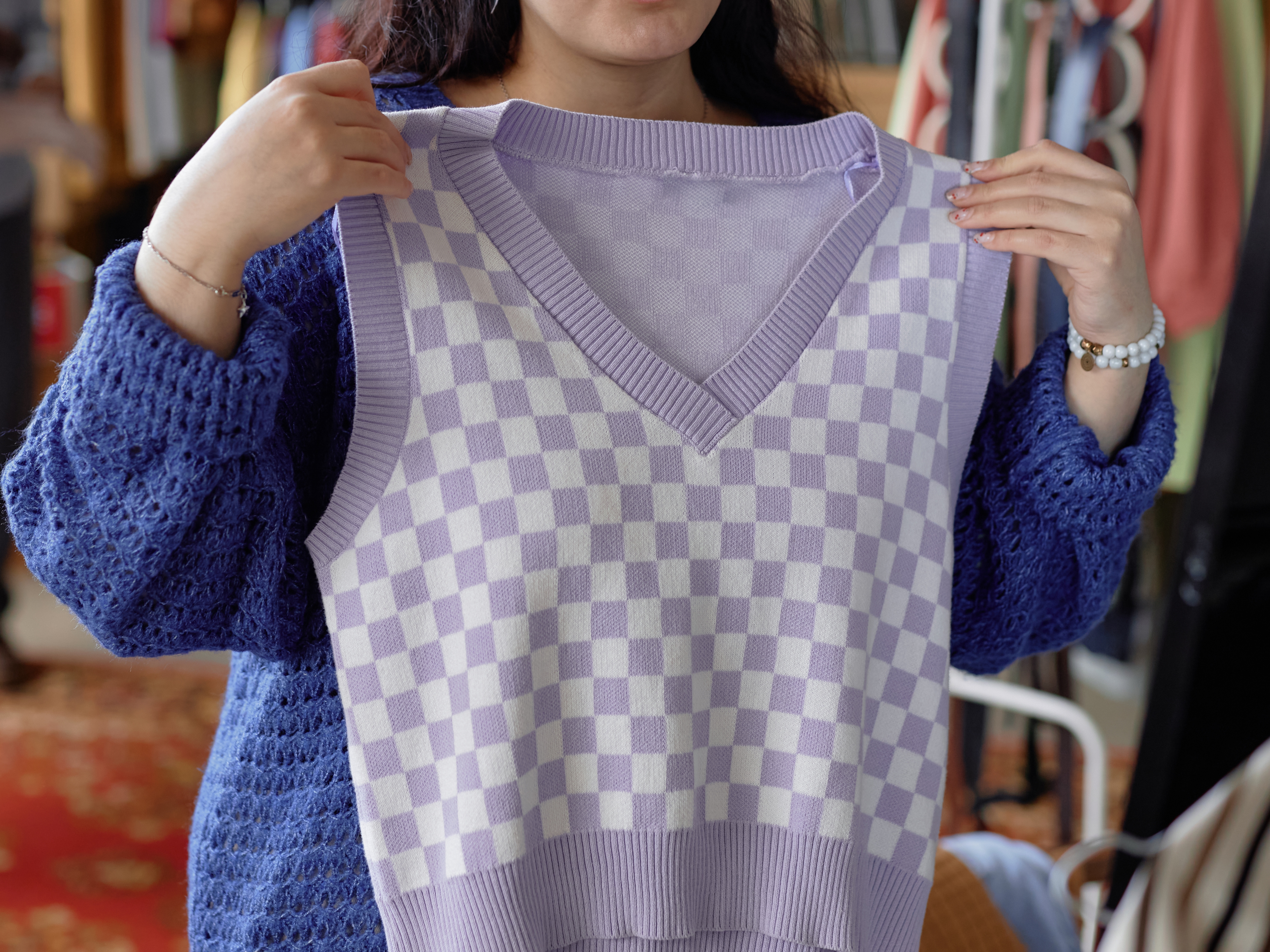 Happy Woman Trying Sweater Vest Shopping at Thrift Store