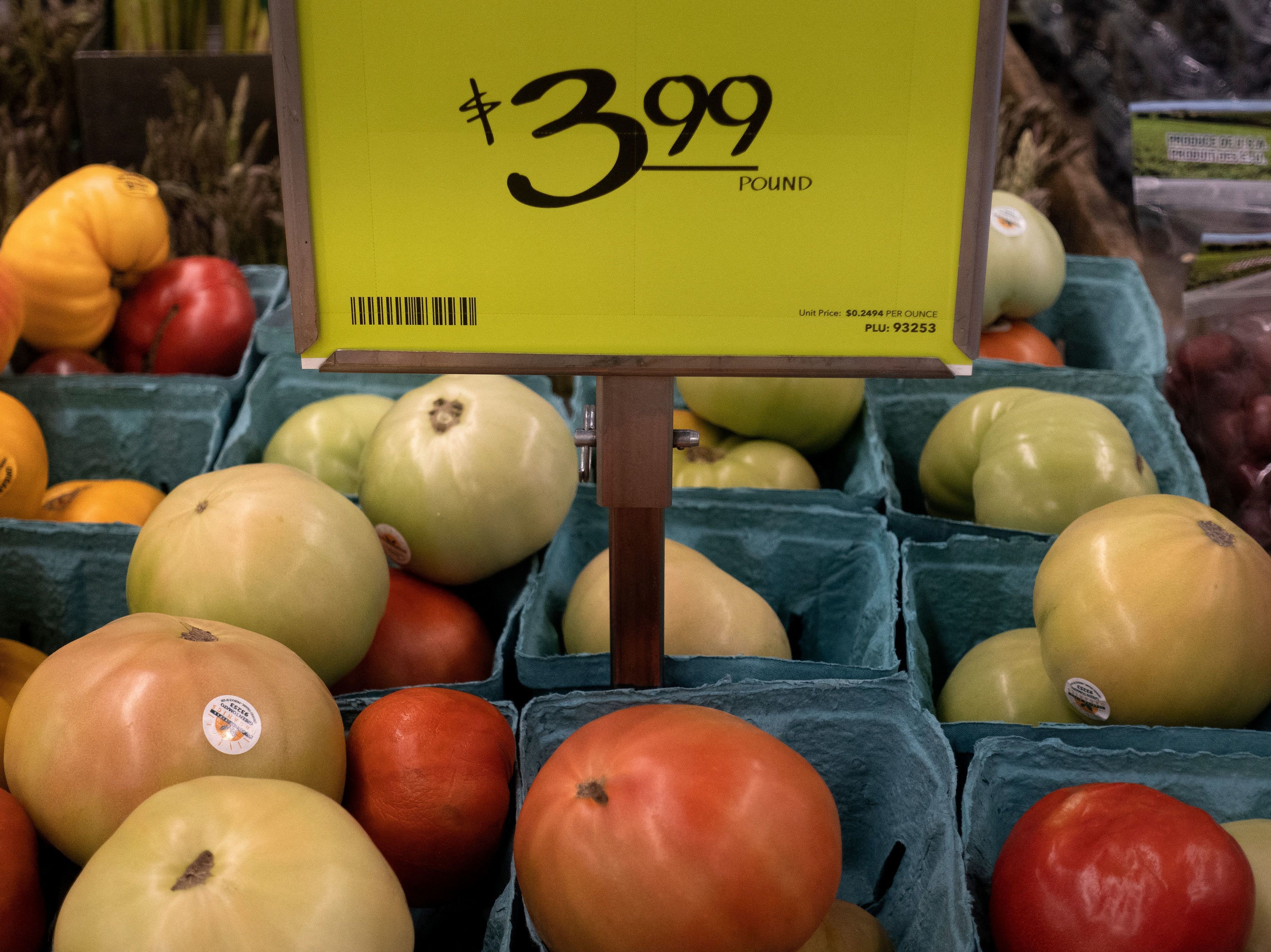 caption: A view of fruit and vegetables at an area grocery store in Washington, D.C., on Aug. 12. Surging prices are hurting households and eroding President Biden's approval rating.