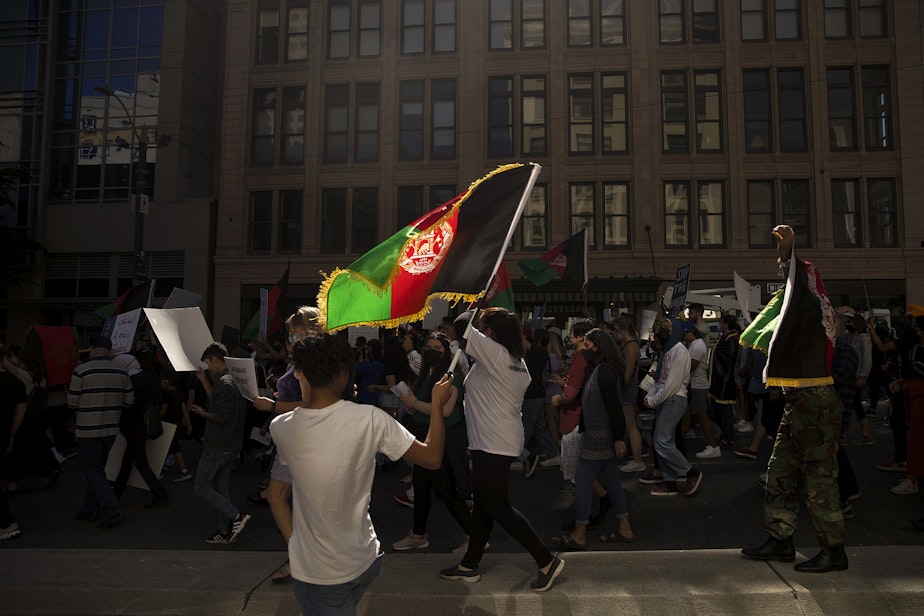 caption: About 100 people attended a rally and march organized by Afghans of Seattle, a new organization composed of young Afghan-Americans in the greater Seattle area, to stand in solidarity with Afghans on Saturday, August 28, 2021, at Westlake Park in Seattle.