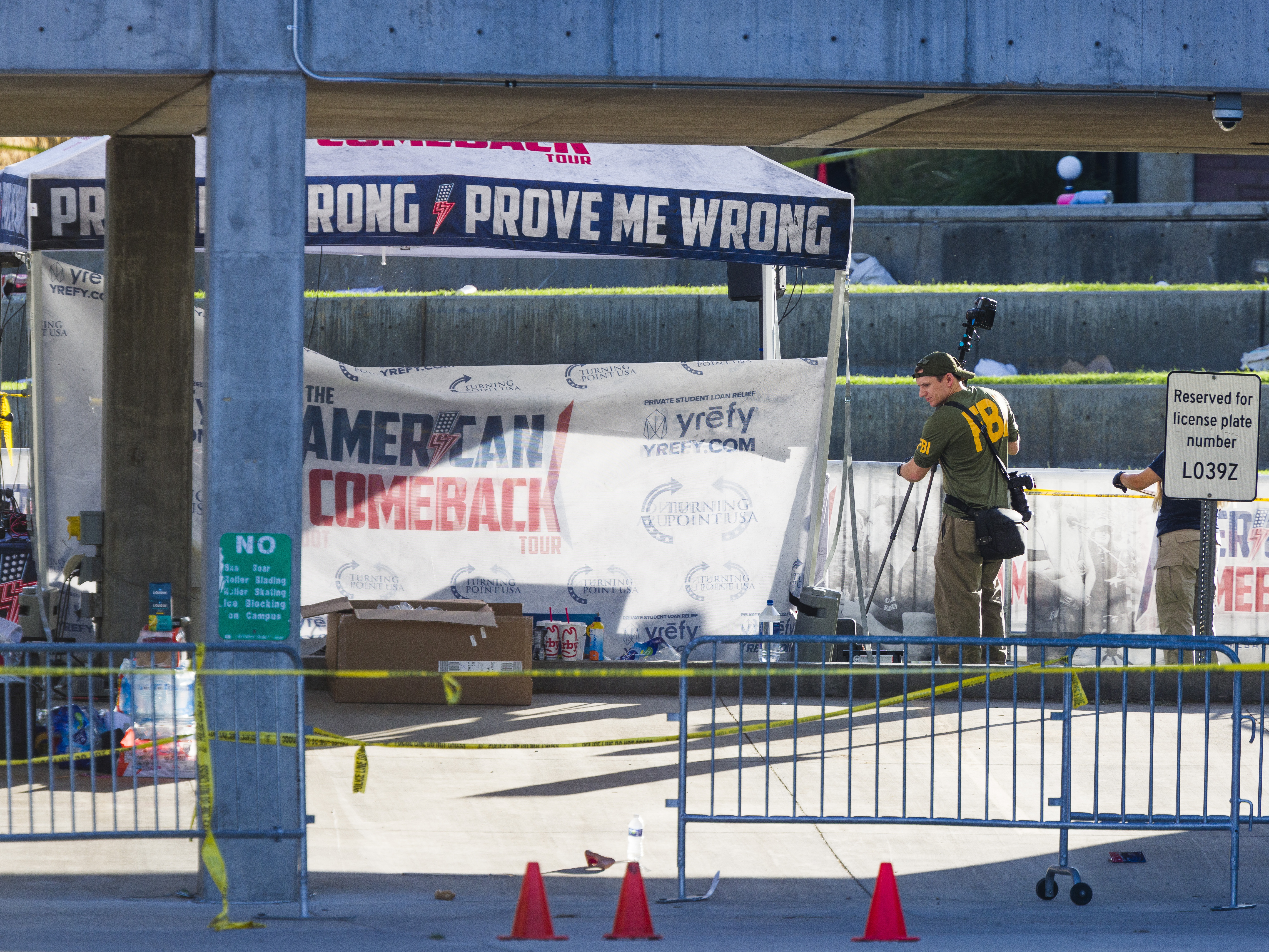 caption: FBI agents walk through the courtyard at Utah Valley University at the site of where political activist Charlie Kirk was killed on Sept. 11, 2025, in Orem, Utah.