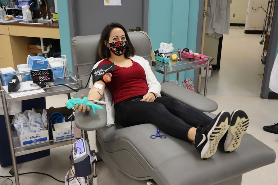 caption: Donor Kaitlan Vasquez giving blood in Olympia on the third anniversary of the Amtrak 501 train wreck.