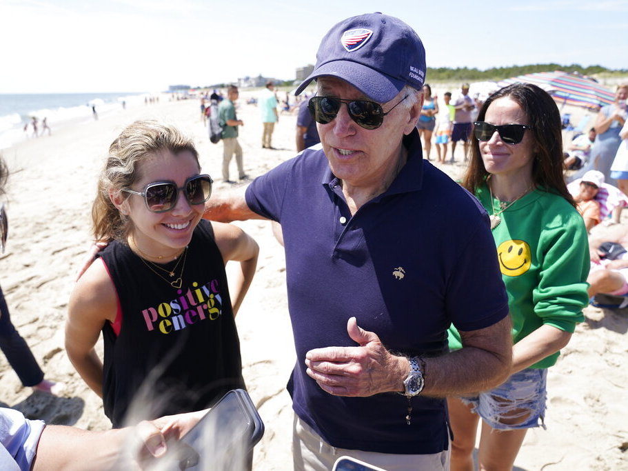 caption: President Joe Biden talks to the media after walking on the beach Monday with his granddaughter Natalie Biden, left, and his daughter Ashley Biden at Rehoboth Beach, Del.