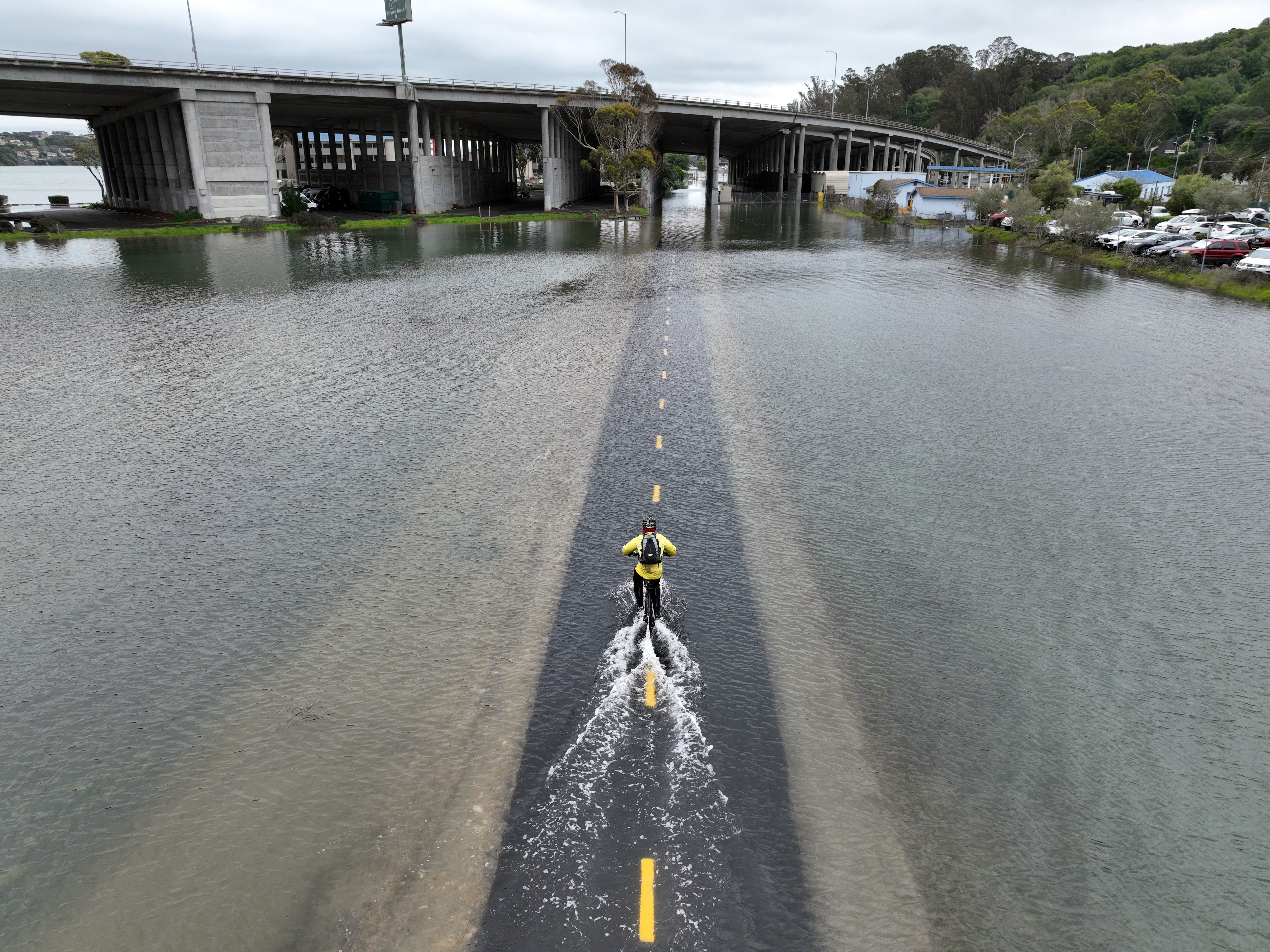 caption: A bike path near Sausalito, Calif. flooded in January during a high tide. Sea levels will rise between six and 18 inches in different parts of the U.S. over the next 30 years, according to a new report.