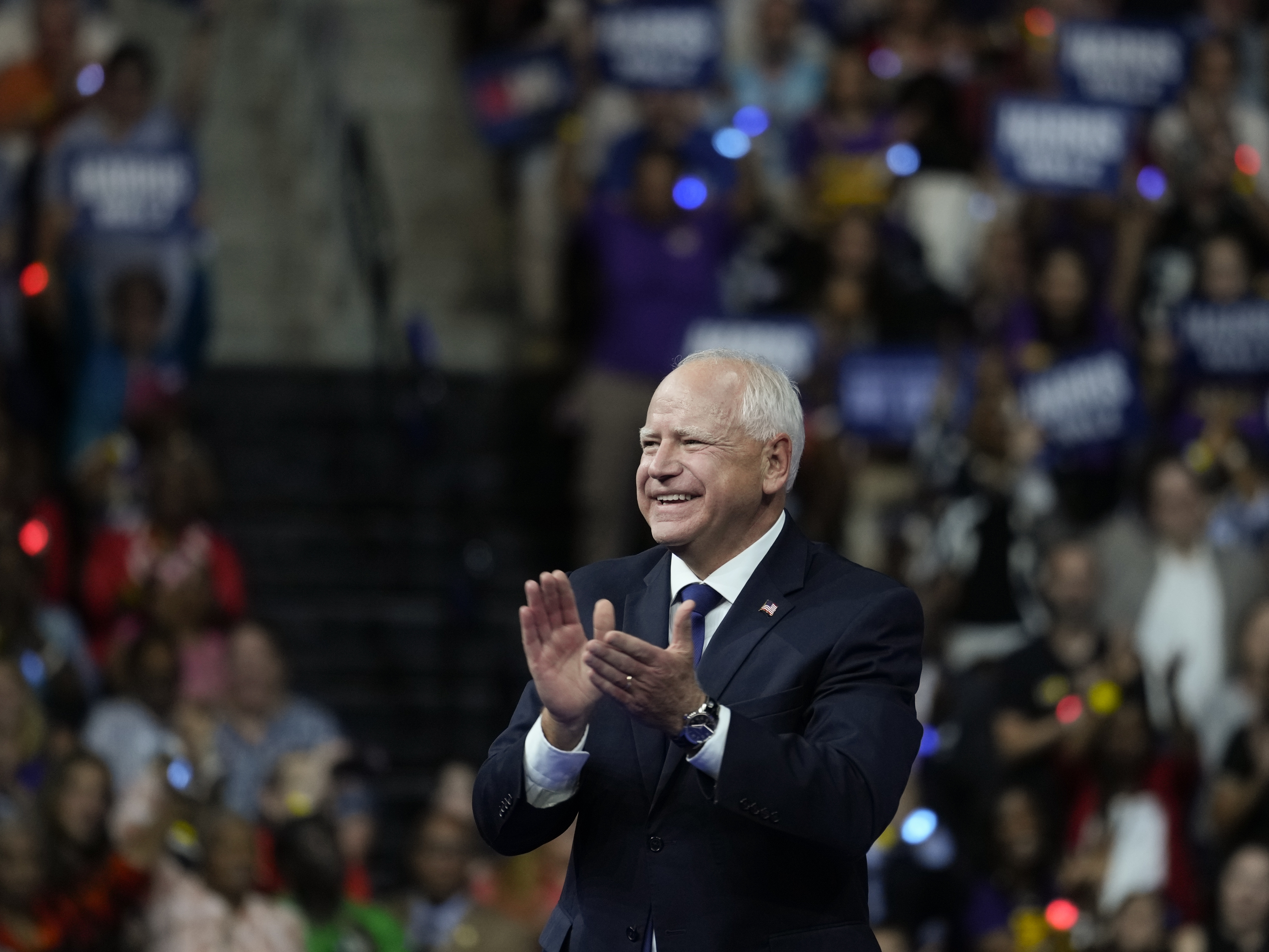 caption: Minnesota Gov. Tim Walz, pictured at a campaign rally in Philadelphia on Tuesday, is getting attention for a law he signed last year requiring public schools to provide free period products.