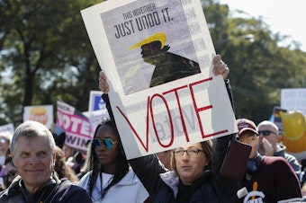 caption: Women gather for a rally and march at Grant Park on Saturday in Chicago to urge voter turnout ahead of the midterm elections. CREDIT: KAMIL KRZACZYNSKI