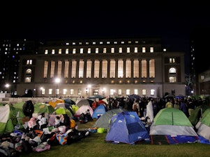 caption: Pro-Palestinian protesters gather at an encampment on the Columbia University campus in New York City on April 25, 2024.