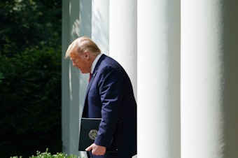caption: President Trump makes his way to the Rose Garden for a signing ceremony at the White House earlier this month.