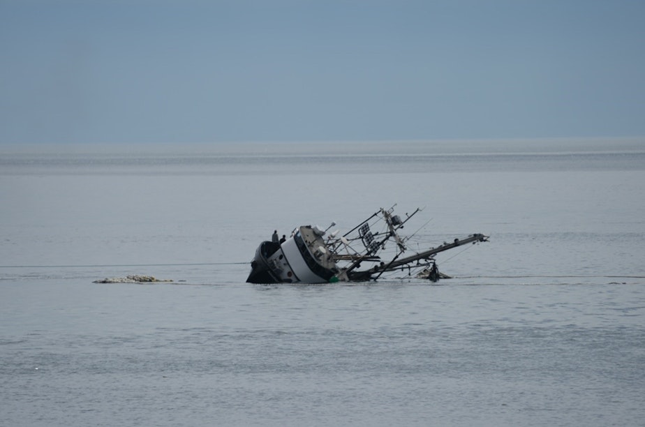 caption: Members of the crew stand near the starboard rail as the Aleutian Isle sinks off San Juan Island on August 14.