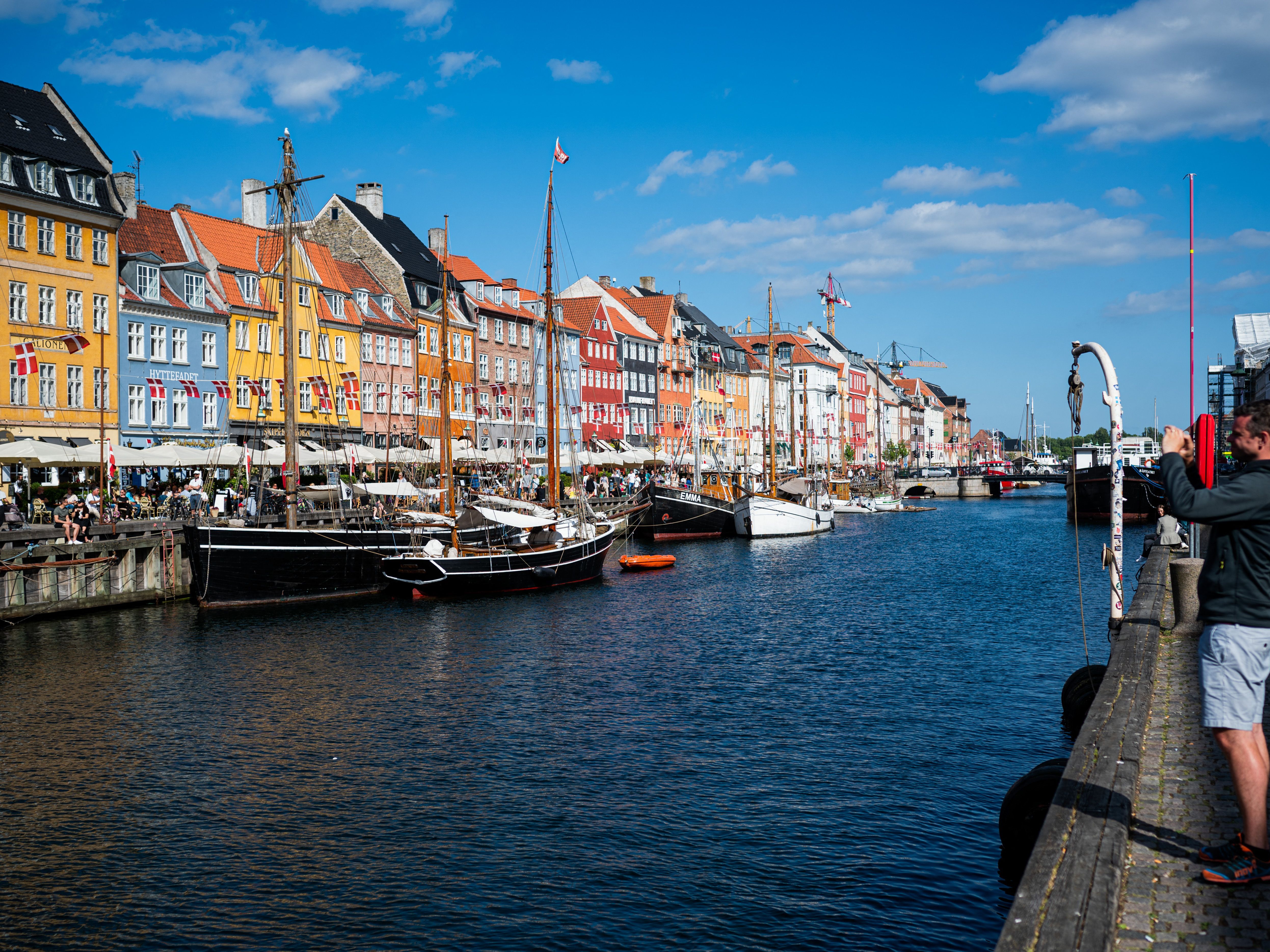 caption: Tourists visit Nyhavn, the 17th-century waterfront, in Copenhagen, Denmark, in this 2021 file photo.