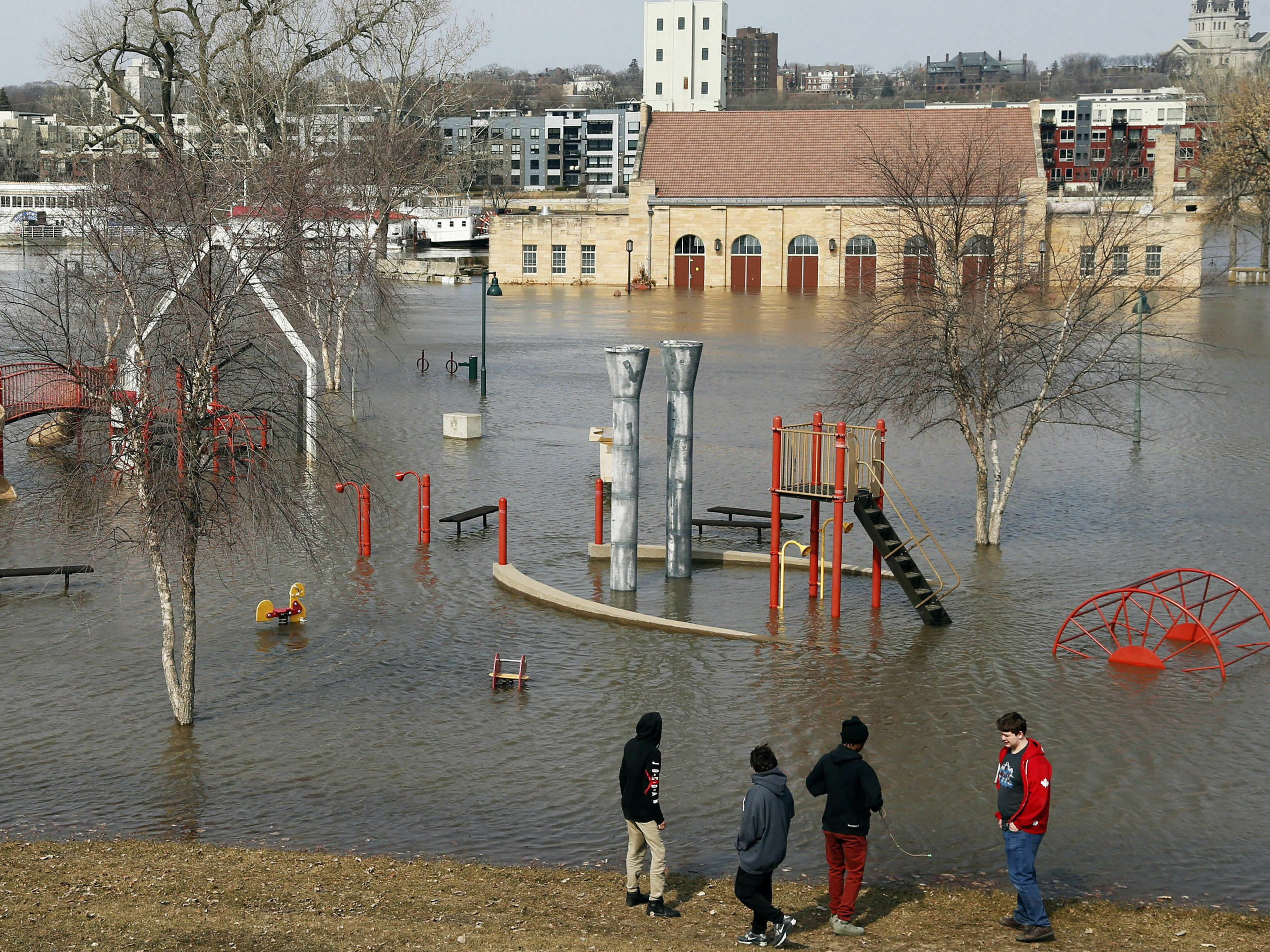 caption: Mississippi River floodwaters inundate the pavilion and a play area at Harriet Island in St. Paul, Minn., this past March.