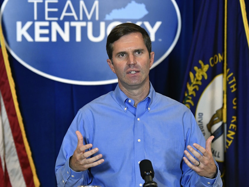 caption: Kentucky Gov. Andy Beshear addresses the media following the return of a grand jury investigation into the death of Breonna Taylor in Frankfort, Ky., on Wednesday. Beshear has made a request to Kentucky Attorney General Daniel Cameron to release the grand jury transcripts to the public.