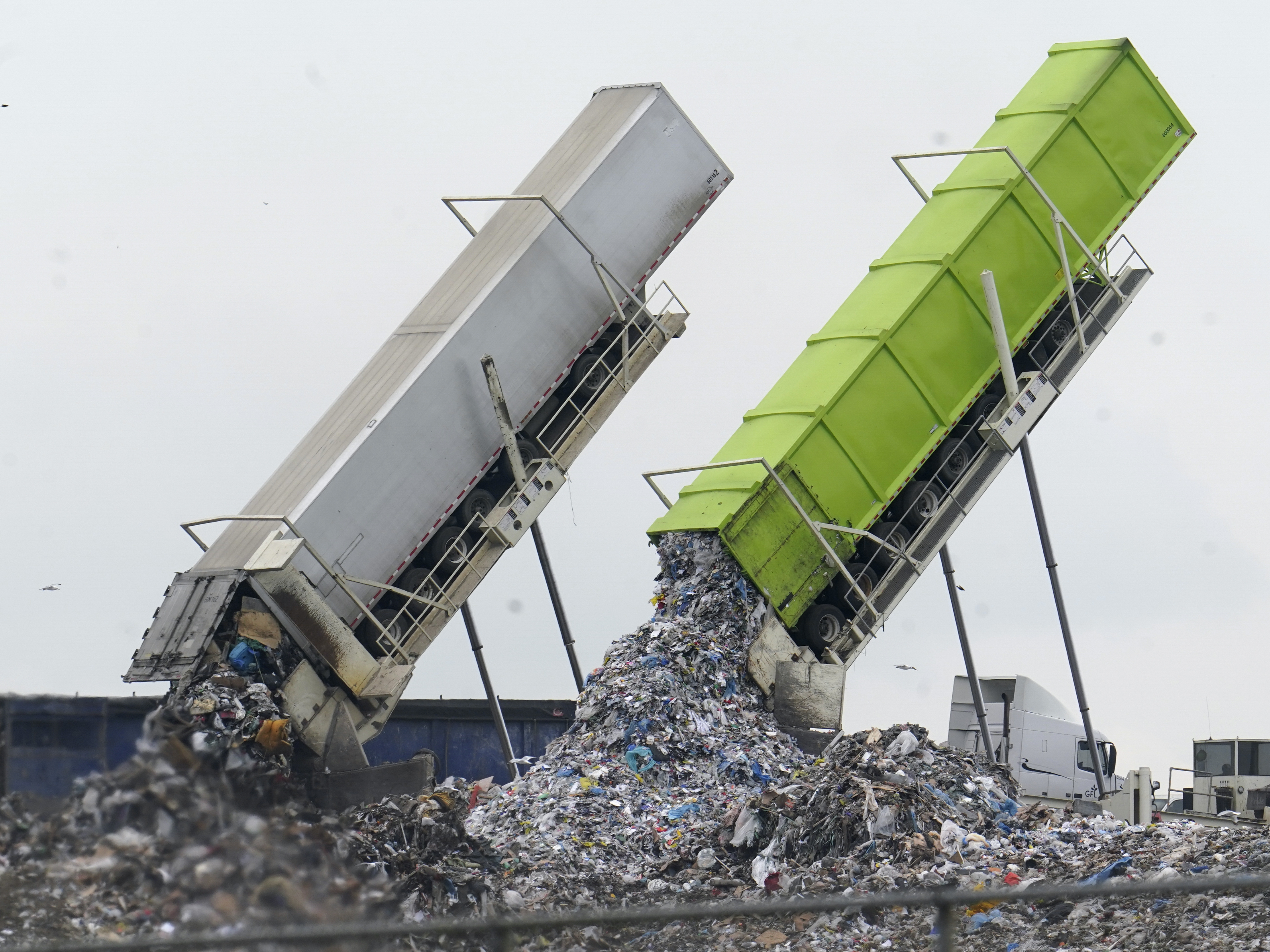 caption: Garbage is unloaded into the Pine Tree Acres Landfill in Lenox Township, Mich., on July 28, 2022. State bans on commercial food waste have been largely ineffective, researchers found.
