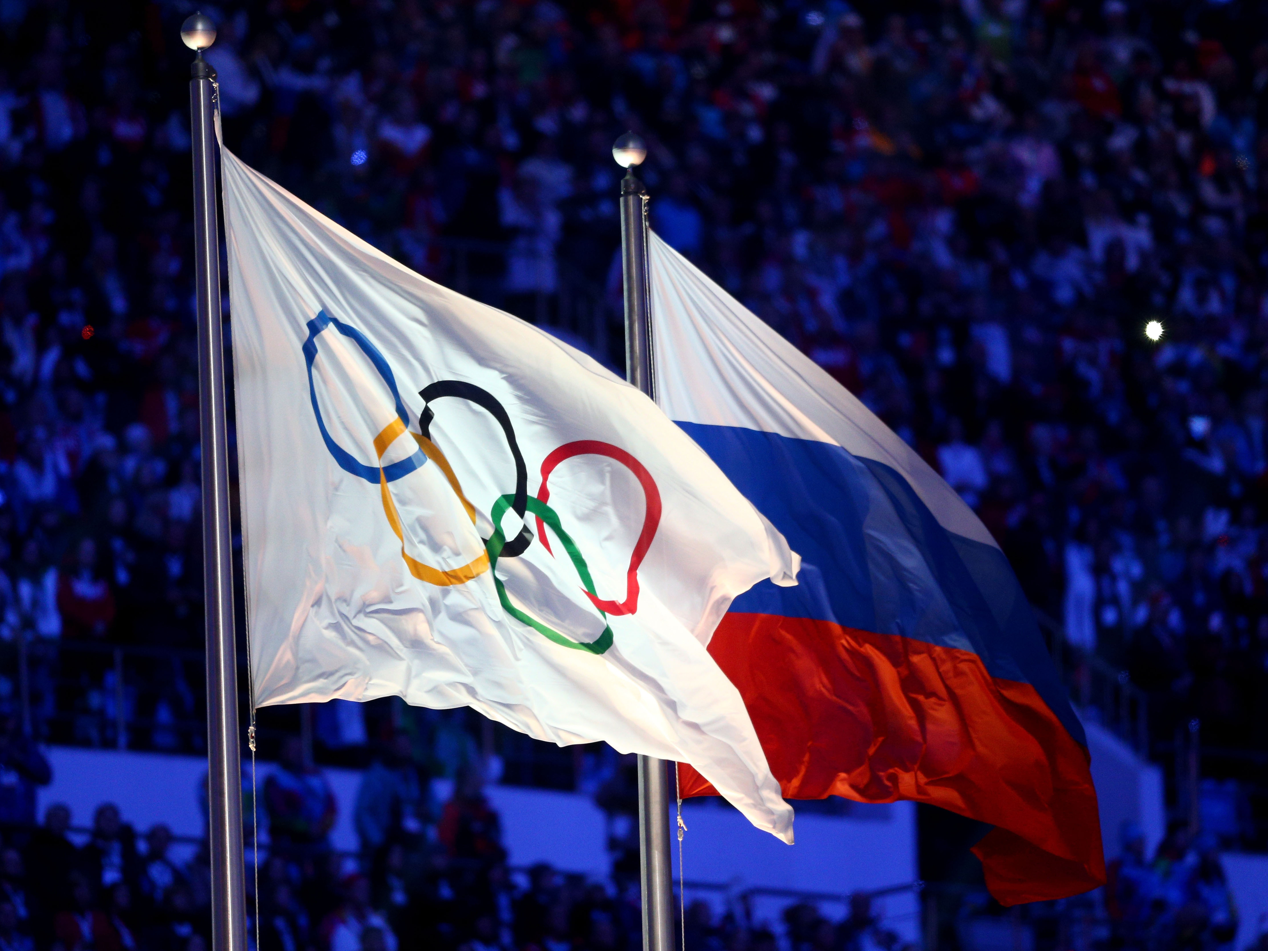 caption: The Olympic flag and Russian flag seen during the Sochi Winter Olympics in 2014.