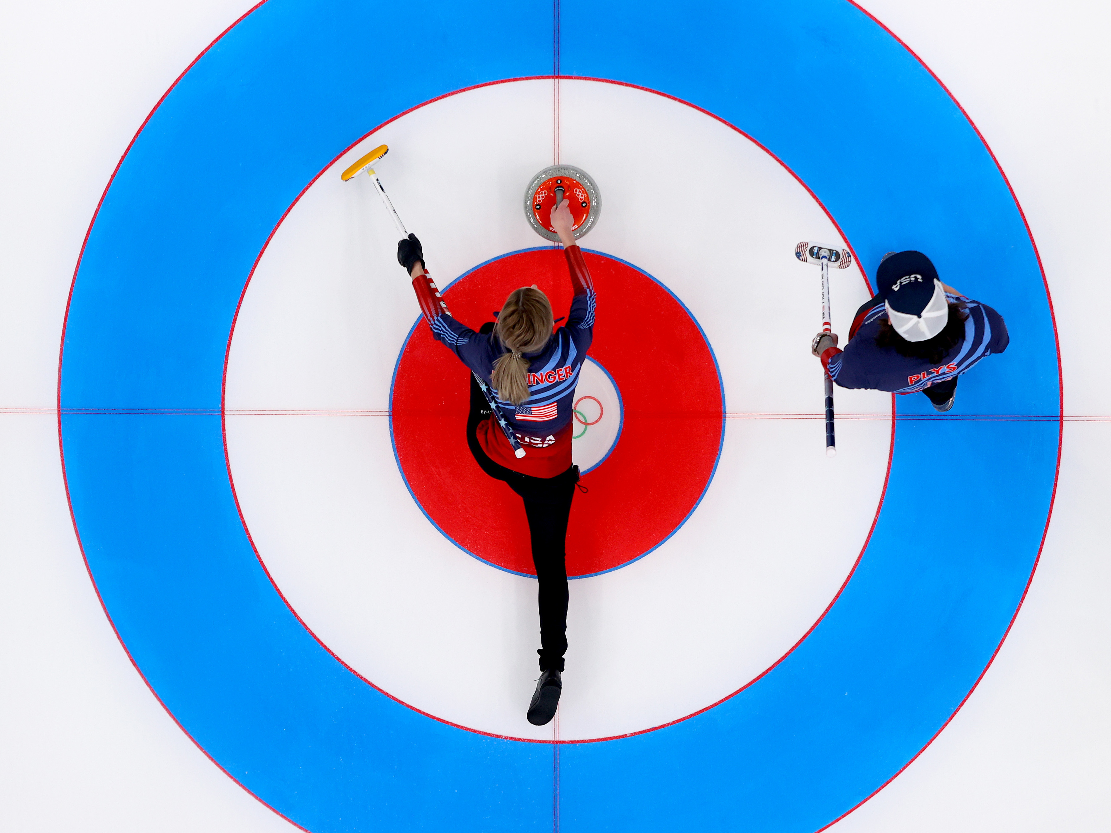 caption: Victoria Persinger (left) and Christopher Plys of Team USA compete against Team Norway during the Curling Mixed Doubles Round Robin ahead of the Beijing 2022 Winter Olympics at the National Aquatics Center in Beijing on on Feb. 3.