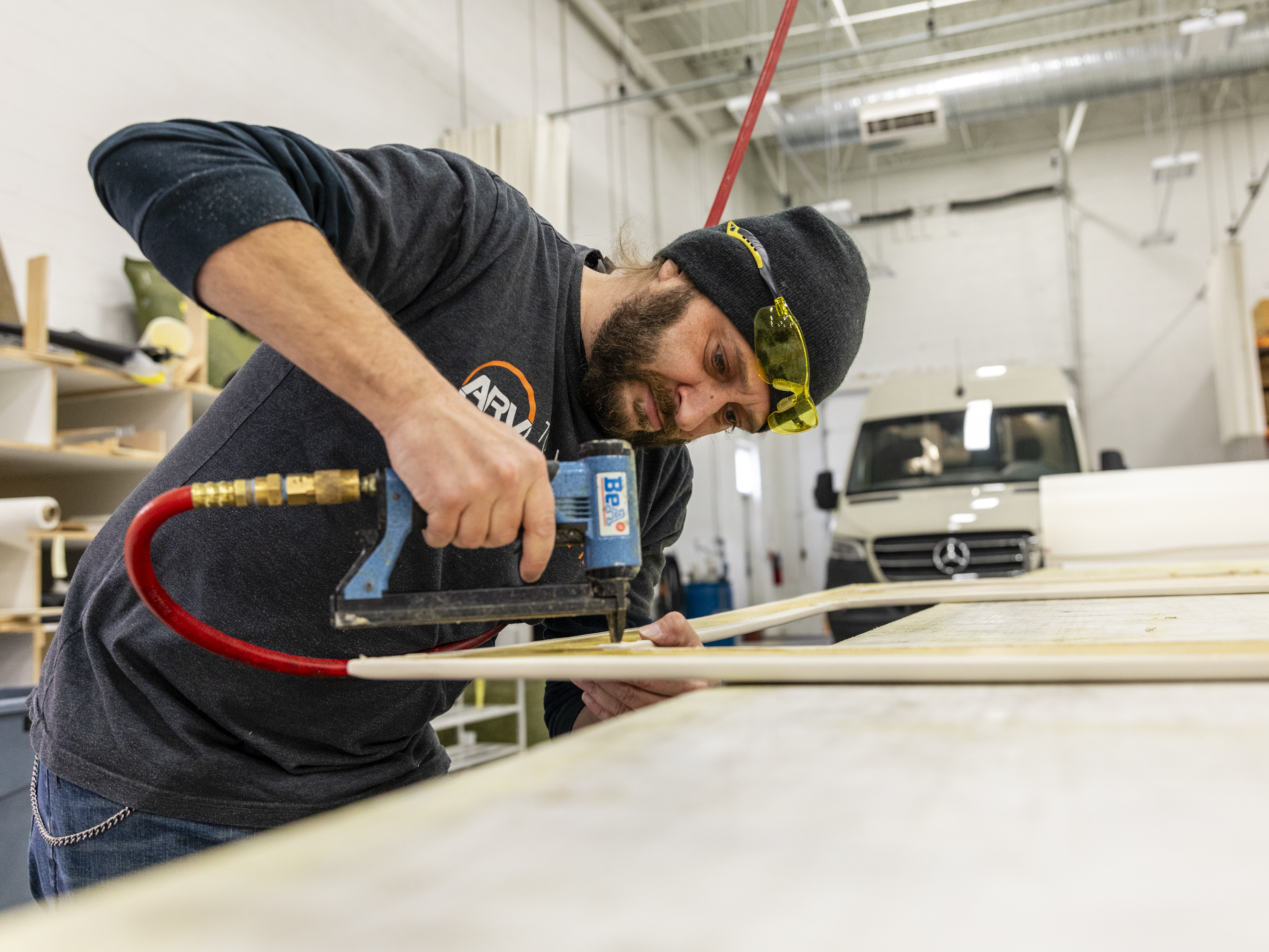 caption: Bill Kowalcic works on wall panels in the finishing department at Advanced RV. After the company went to a four-day workweek, his team figured out how to cut time without cutting corners.