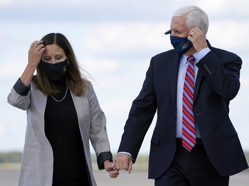 caption: Vice President Mike Pence and his wife, Karen Pence, are wearing masks in an attempt to protect themselves against the coronavirus.