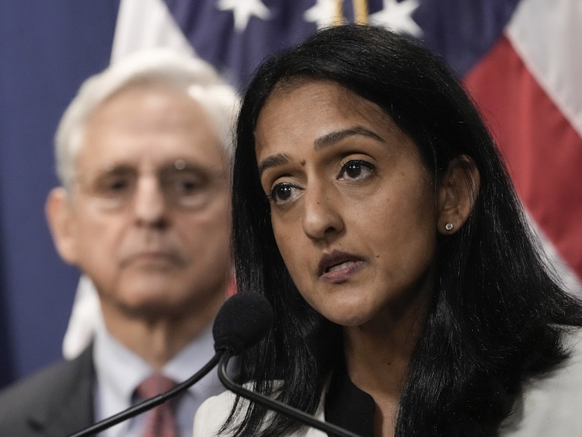 caption: Associate Attorney General Vanita Gupta speaks during a news conference at the Justice Department on Aug. 2, 2022, as Attorney General Merrick Garland looks on.